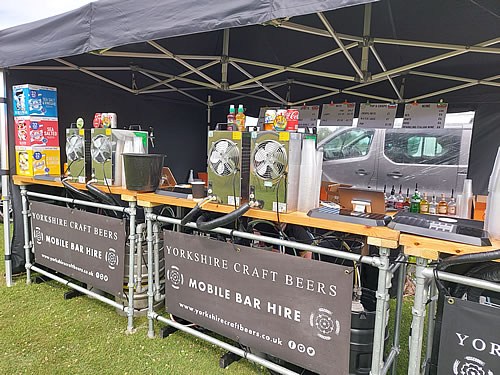 Mobile bar under a marquee serving craft beer to guests at a charity fundraising event in Pontefract