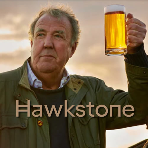 Photograph of Jeremy Clarkson holding a pint of lager and a Hawkstone logo