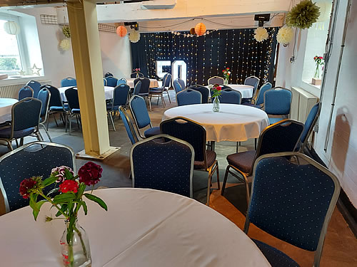 Queens Mill room for hire decorated with paper pom poms for a party