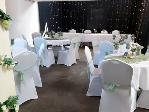 Tables and chairs decorated for a wedding at the Queens Mill
