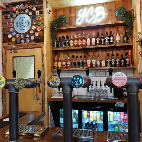 Craft beer taps on the bar and spirits on shelves
